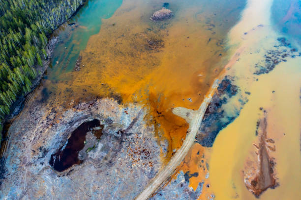istock Dried rusty river bed over wasteland grey background, contamination texture, drone view directly above 1485243612