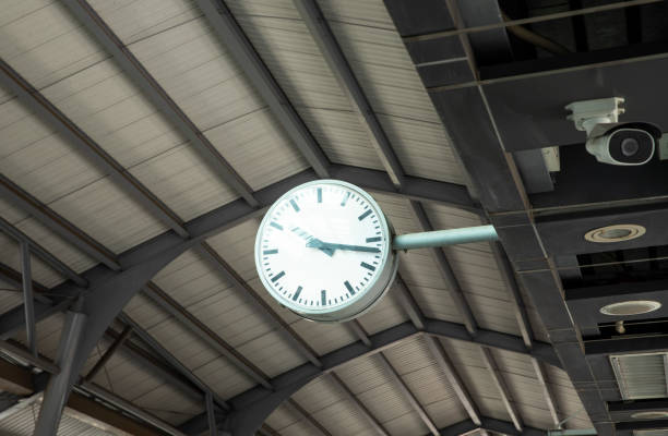 istock Public clock in sky train station with cctv. 1485244514