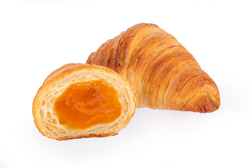 Fresh croissant with orange filling isolated on white background. croissants with berry filling on a white background