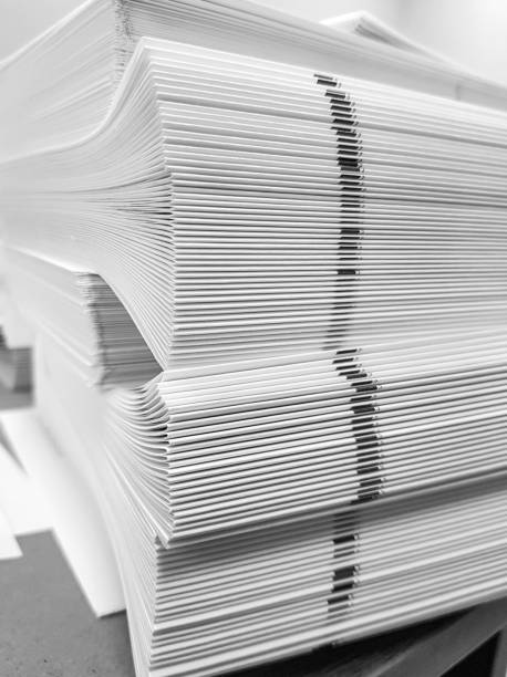 istock A stack of blank paper, book blocks prepared for binding in a printing house 1485248364