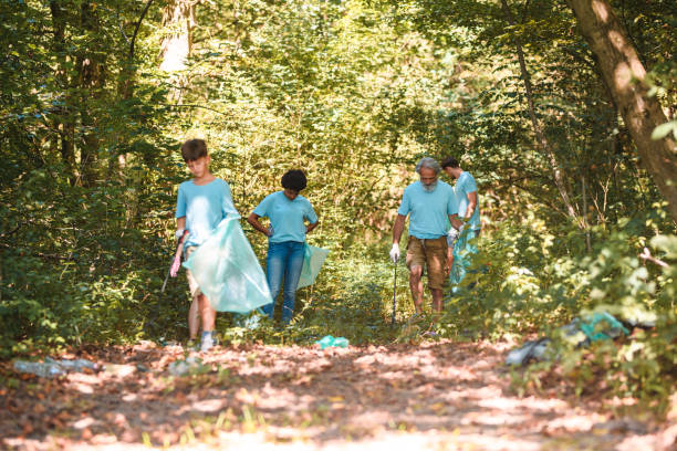 istock Blue Uniformed Responsible Adults and Kid Checking on Trash 1485249818