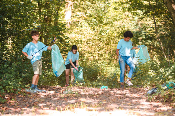 Active Diverse Community Putting Trash Away in Blue Plastic Bags
