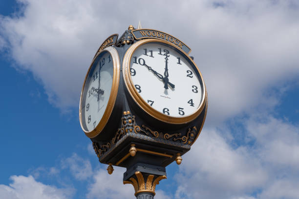 Town Clock Woodstock, Illinois - United States - April 24th, 2023: Woodstock town clock with blue skies and clouds in the background. groundhog day clock stock pictures, royalty-free photos & images