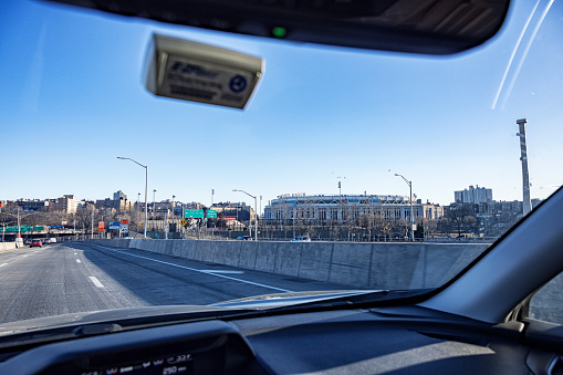 View of Yankee Stadium, the home field of the New York Yankees Major League Baseball team. Photo taken from a moving car on the northbound Major Deegan Expressway / New York State Thruway (Route I-87) on March 8, 2023.