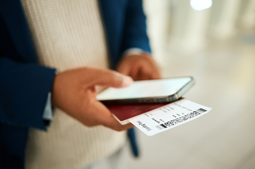 Phone, airport ticket and man hands for online booking, fintech and digital payment notification. Mobile app, screen mockup and person typing flight information with passport and identity document