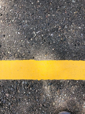 Central Sulawesi, Indonesia - April 23, 2023 : road with bright yellow road lines