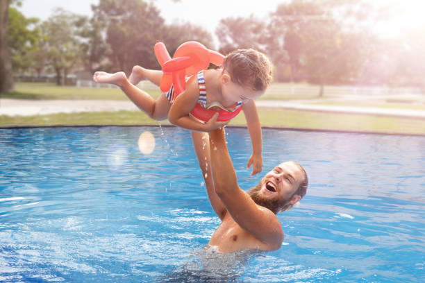 istock Dad with child in the pool 1485268519