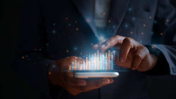 istock The businessman trader investor analyst uses the mobile phone app analytics to analyze cryptocurrency financial market data, trading data index charts, and graphs on a laptop and a smartphone. 1485269623