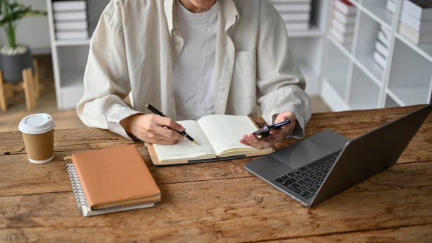 istock A college student taking a note and reading textbook in the study room. 1485272445