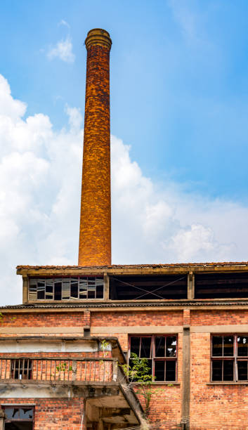 istock Abandoned red brick factory building and big chimney 1485279016