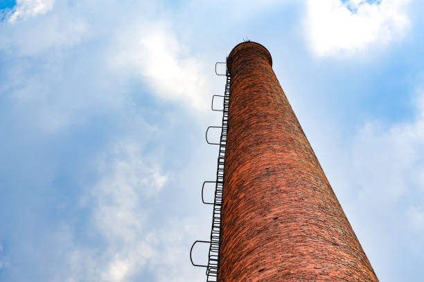 istock Abandoned red brick factory building and big chimney 1485279694