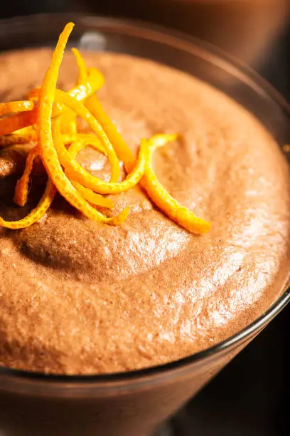 Light and airy orange chocolate mousse with decorative orange strands.