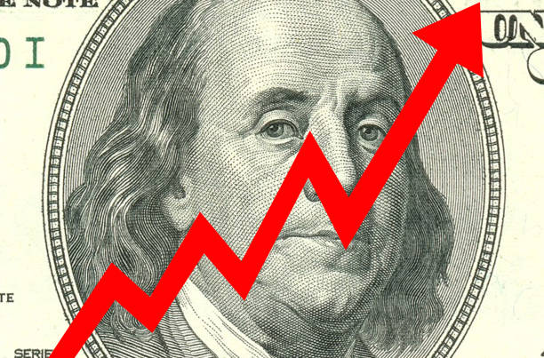 istock A large red arrow pointing down on a 100 dollar (USD) bill. Currency competition conceptual image. Currency devaluation 1485284363