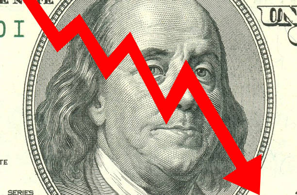 istock A large red arrow pointing down on a 100 dollar (USD) bill. Currency competition conceptual image. Currency devaluation 1485286544