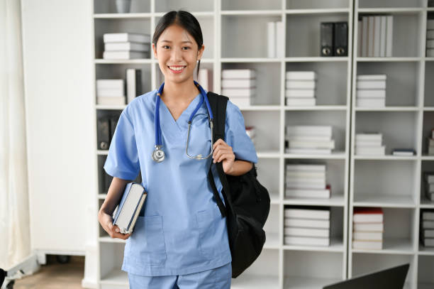 istock Young Asian medical student smiling and standing in the study room with stethoscope 1485287931
