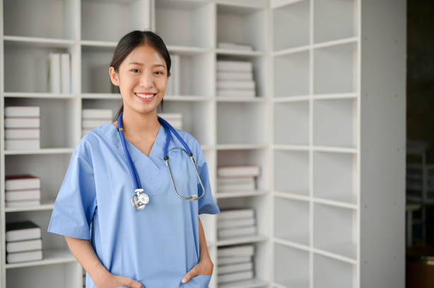 istock Young Asian medical student smiling and standing in the study room. 1485287944