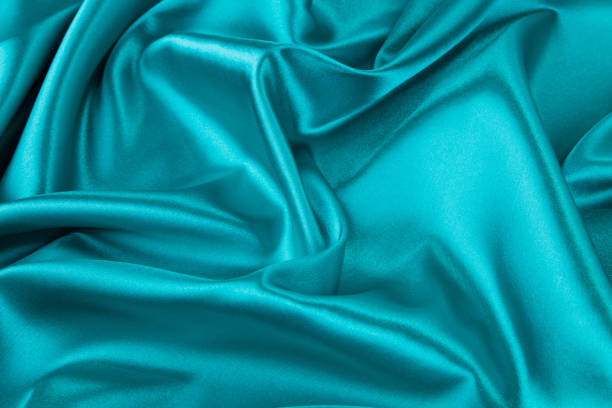 istock Soft folds of blue silk cloth texture. 1485290750