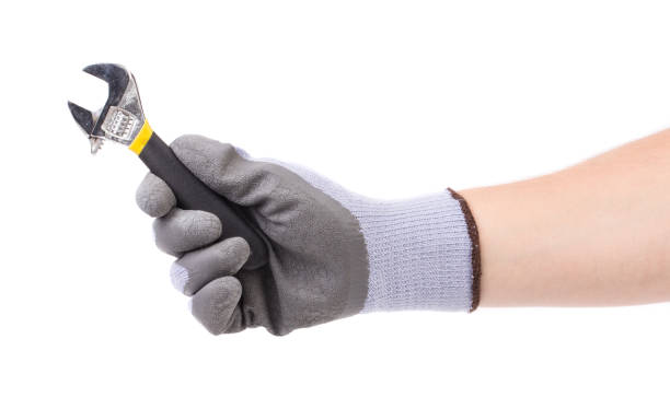 istock Gloved hand holds an adjustable wrench. 1485290834
