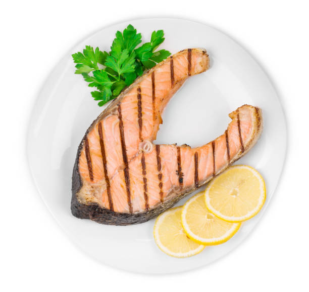 istock Grilled salmon steak with vegetables on plate. 1485290928