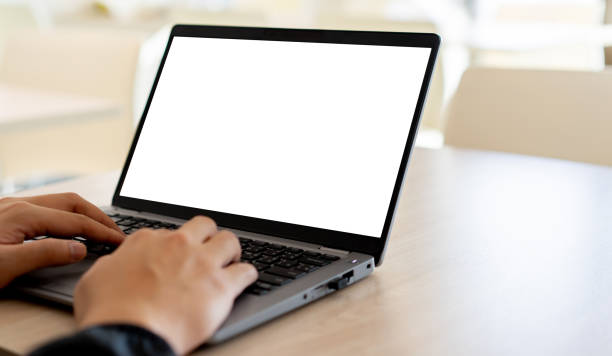 istock close up on white blank mockup display (isolated) with employee young man hand typing on laptop to check or work on table for business technology concept 1485300972