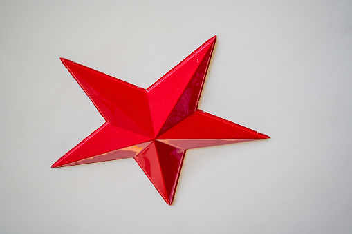 Close-up of a bright red five-pointed star sculpture