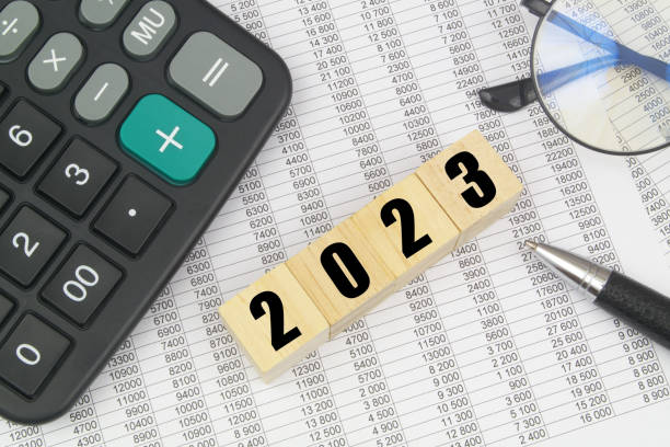 istock Numbers 2023 on cubes, calculator, pen and eyeglasses on documents. 1485305624