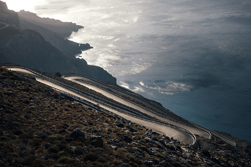 Winding mountain road (South Crete, Tris Ekklisies, Greece) illuminated by the morning sunlight.
