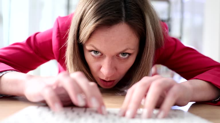 A business woman lying typing on the keyboard, a close-up