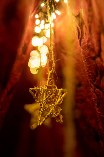Golden star shapes shine brightly on the Christmas tree.