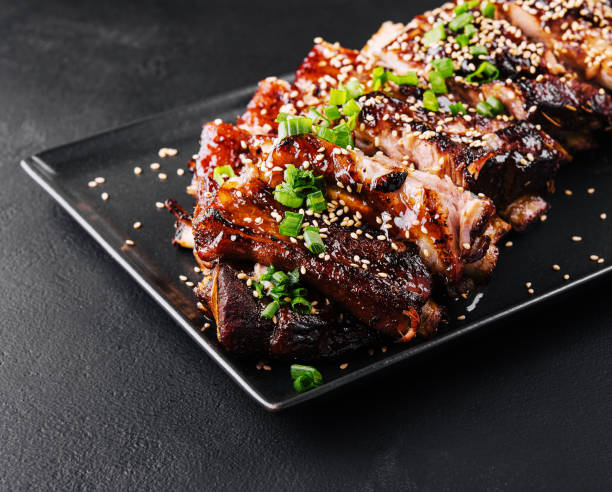 istock sliced BBQ pork ribs on black plate 1485308498
