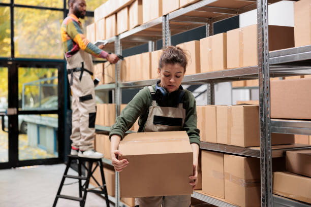istock Worker carrying cardboard box working in storage room 1485310471