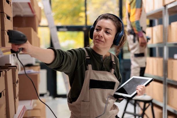 istock Supervisor wearing headset listening music during inventory 1485311204