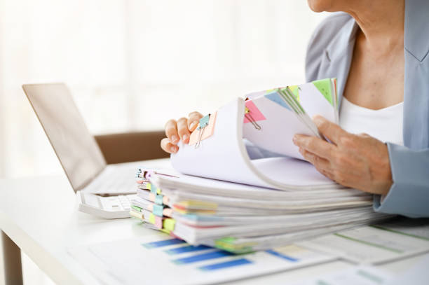 istock Close up view of middle aged businesswoman working with documents 1485314877