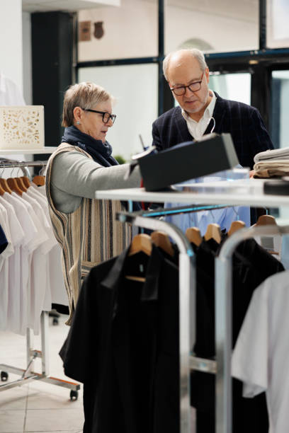 istock Elderly couple looking at blue stylish shirt analyzing fabric 1485317047