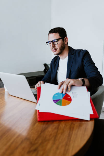 istock young latin businessman working and using laptop or computer in smart casual clothes at office in Mexico, hispanic people 1485318790