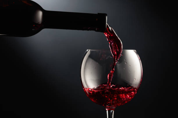 istock Pouring red wine into a wine glass. 1485322961