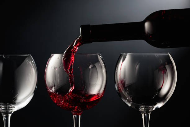istock Pouring red wine into a wine glass. 1485322981