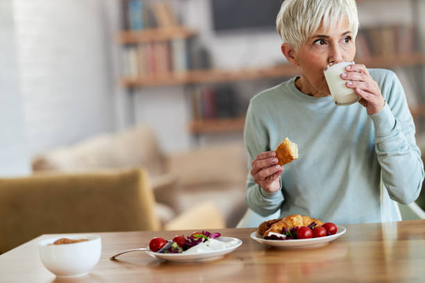 istock Senior woman having breakfast at home. 1485323041