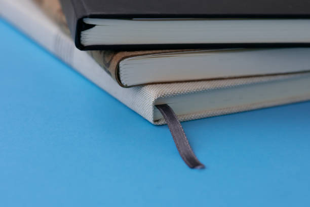 istock Group of notebooks on blue background. Concept of order on workplace during studying or working. 1485323221