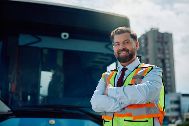 istock Happy bus driver with arms crossed looking at camera. 1485323605