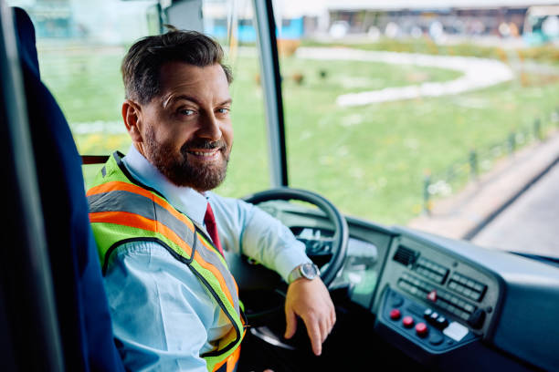 istock Happy bus driver inside the bus looking at camera. 1485323685