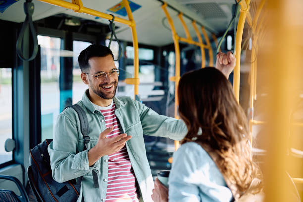 istock Young couple talking and laughing while commuting by bus. 1485324033