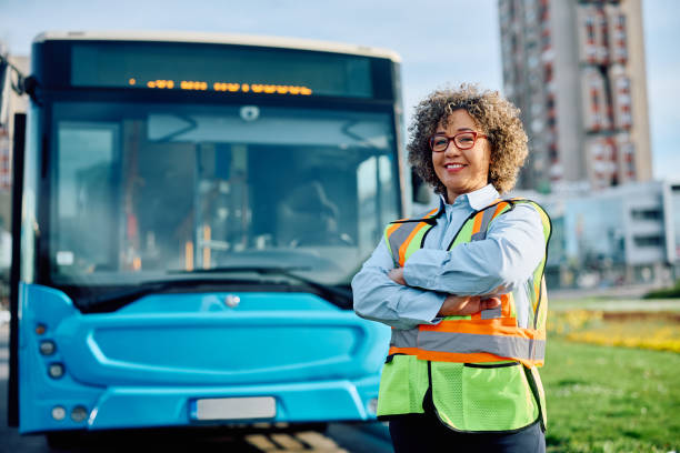 istock Happy bus driver standing with her arms crossed and looking at camera. 1485324207