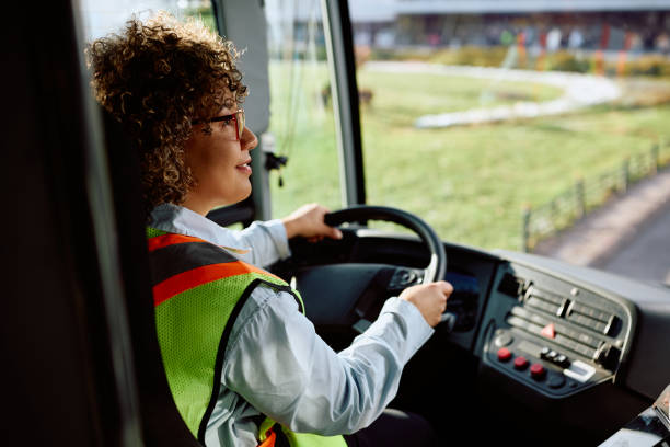 istock Female bus driver behind the steering wheel. 1485324225