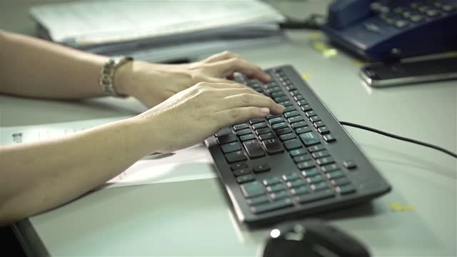 Chinese Women Typing On Black Keyboard - Side Angle With Movement