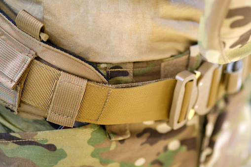 Army pouches and a holster with weapons for military uniforms. Bags for items and cartridges for the machine