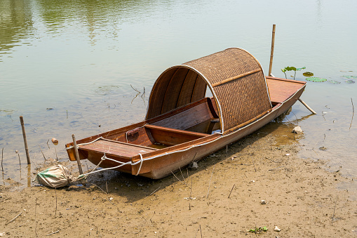 A retro bamboo fishing boat by the river, a boat used by traditional fishermen