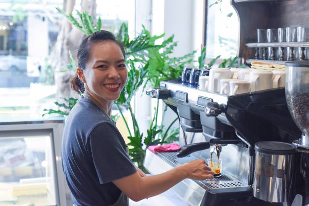 istock Vietnamese barista making espresso with coffee machine close up 1485327470