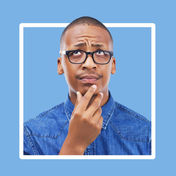istock Confused, thinking and black man in studio with frame, mockup and blue background space. Doubt, unsure and contemplation with a guy thoughtful in border, pensive or emoji collage while isolated 1485327493