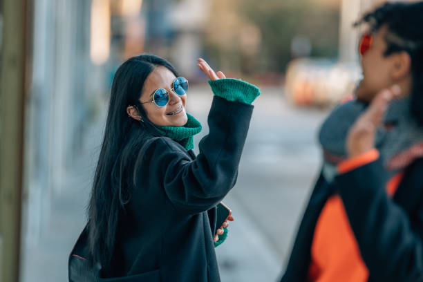 istock friends on the street greeting each other 1485330157